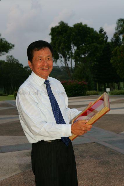 James Lee Kim Wah holding the Medal of Commendation (Gold) award which he received during May Day Dinner at Orchid Country Club