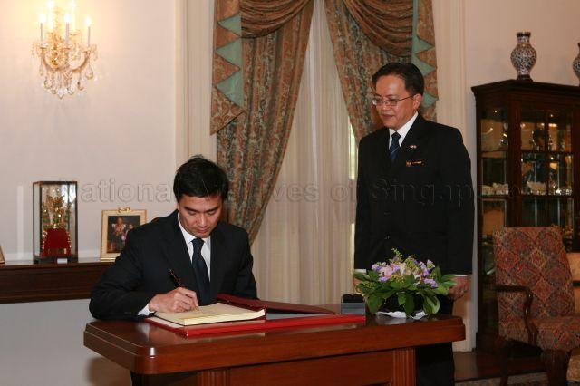 Prime Minister Abhisit Vejjajiva of Thailand signing the guest book when he arrives at Istana to call on President S R Nathan