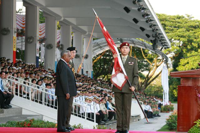 President S R Nathan presenting State Colours to Lieutenant Colonel Edwin Goh Tiong Cheng, Commanding Officer of the 1st Commando Battalion which won the Best Combat Unit award, during Singapore Armed Forces (SAF) Day parade at SAFTI Military Institute. Also present is Chief of Defence Force Lieutenant General Desmond Kuek.