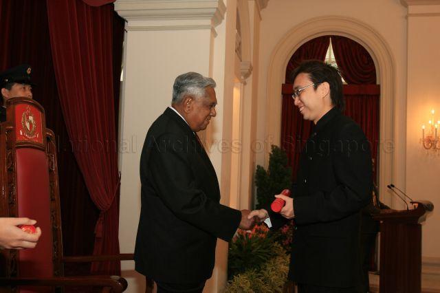 President S R Nathan presenting instrument of appointment to Nominated Member of Parliament Calvin Cheng, a fashion and media entrepreneur, at ceremony held at the State Room, Istana