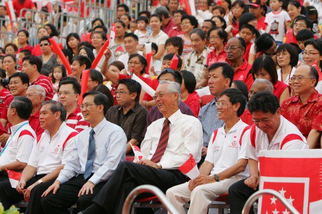 Senior Minister Goh Chok Tong and Member of Parliament for Marine Parade Group Representation Constituency (GRC) Lim Biow Chuan at mini-National Day parade organised by Mountbatten grassroots organisations held at surface car park behind Block 51 in Old Airport Road. Seated second from right is marathon runner and grassroots leader Lim Nghee Huat.