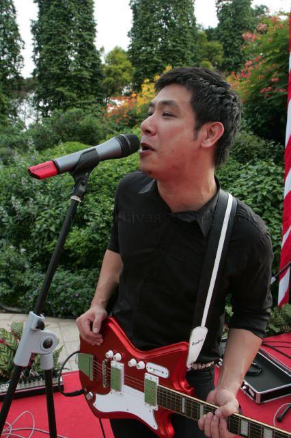 Singer/guitarist David Tan of local band Electrico performing National Day's song "What Do You See?" during National Day reception at Istana Lawn hosted by President S R Nathan