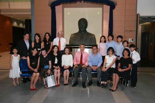 Prime Minister Lee Hsien Loong, Dr Lee Wei Ling (seated, second from left) and descendants of Khoo Teck Puat, including his children Elizabeth Khoo (seated, third from left), Mavis Khoo (seated, fourth from left) and film director Eric Khoo (seated, third from right), posing for photographs in front of the late tycoon's bust during the official opening of Duke-National University of Singapore (NUS) Graduate Medical School and its new campus, the Khoo Teck Puat Building, at 8 College Road. The medical school is supported by an $80 million donation from the Estate of Khoo Teck Puat, which was matched dollar-for-dollar by a contribution from the Singapore government.