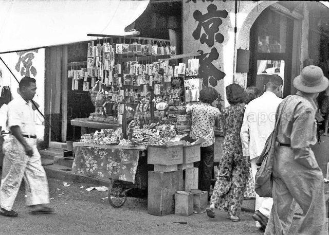Roadside hawker selling snacks and cards, c.1950s
