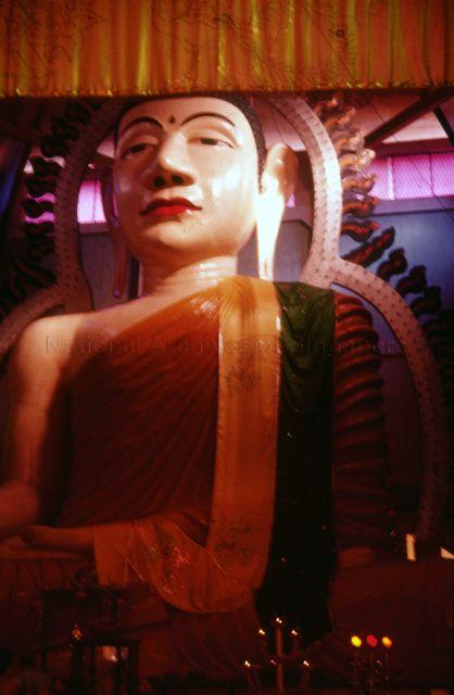 Statue of Buddha in the Sakya Muni Buddha Gaya Temple (Temple of 1,000 Lights) at Race Course Road. The temple was founded by Venerable Vutthisara, a Thai monk in 1927.