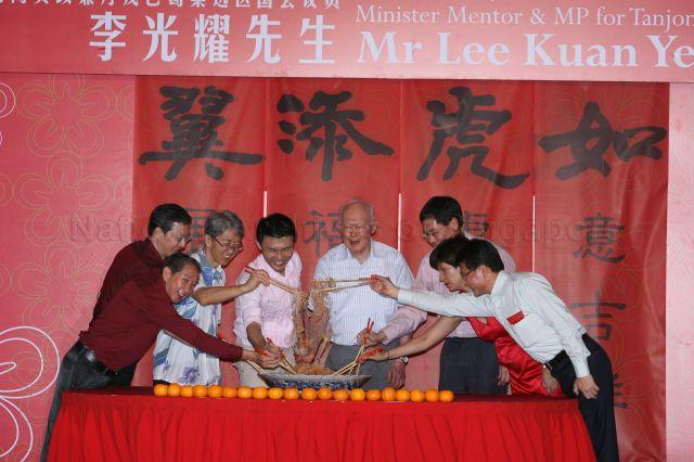 Minister Mentor Lee Kuan Yew with Members of Parliament for Tanjong Pagar Group Representation Constituency (GRC) and grassroots leaders tossing yusheng (or 'lo hei' in Cantonese, meaning â€˜tossing luckâ€™) during Lunar New Year celebration dinner at Block 46-2 Commonwealth Drive