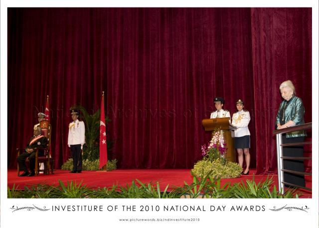 Recipient of the Meritorious Service Medal, Mrs Ann Elizabeth Wee, former adviser to the Juvenile Court and former member of the Tribunal for the Maintenance of Parents, during investiture of National Day awards held at University Cultural Centre, National University of Singapore. Seated on left is President S R Nathan.