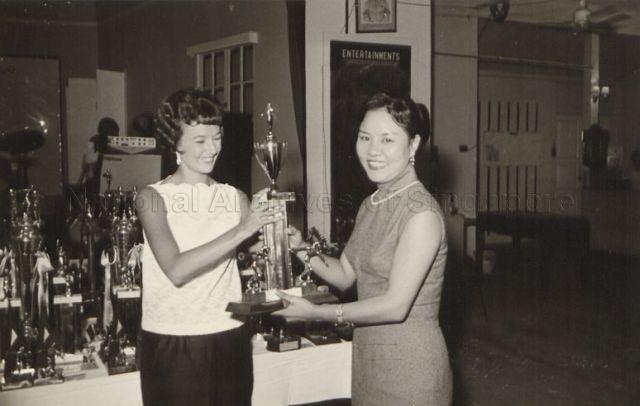 Mrs Helen Wong Kwok Leong nee Mah Jia Lan (left) receiving the winner's trophy for the Malaysia National Bowling tournament championship