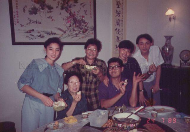 Actor Chow Yun-Fat (seated right) having durian with Mrs Wong Kwok Leong nee Mah Jia Lan (third from right) and her family. Seated on Chow's right is his mother while second from right is his wife Jasmine.