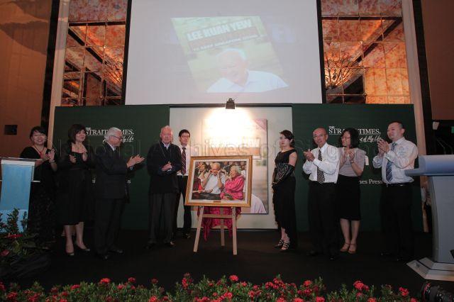 The authors of “Lee Kuan Yew: Hard Truths to Keep Singapore Going” presenting a photograph of Mr and Mrs Lee Kuan Yew at a community event as a gift to Minister Mentor Lee during the book launch held at John Jacob Ballroom, the St Regis Singapore