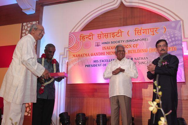 Chairman of Mahatma Gandhi Memorial Shriniwas Rai (left) presenting a gift to Senior Minister Professor S Jayakumar during opening of the restored Memorial Building at 3 Race Course Lane. Also on stage are President S R Nathan and President of the Hindi Society Ranvir Kumar Singh (right).
