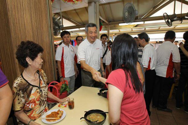 Prime Minister Lee Hsien Loong interacting with residents at hawker centre during his walkabout in Teck Ghee Division of Ang Mo Kio Group Representation Constituency (GRC) after hongbao presentation ceremony held at Teck Ghee Community Club