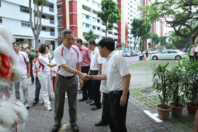 Prime Minister Lee Hsien Loong being greeted upon arrival at Block 420, Ang Mo Kio Avenue 10, to open Community Care Network (CCN) community fair for senior citizens and to launch CCN Senior Activity Centre (CCNSAC)