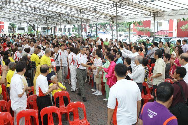 Grassroots leaders and residents welcoming Prime Minister Lee Hsien Loong as he arrives for opening of Community Care Network (CCN) community fair for senior citizens and launch of CCN Senior Activity Centre (CCNSAC) at Block 420, Ang Mo Kio Avenue 10