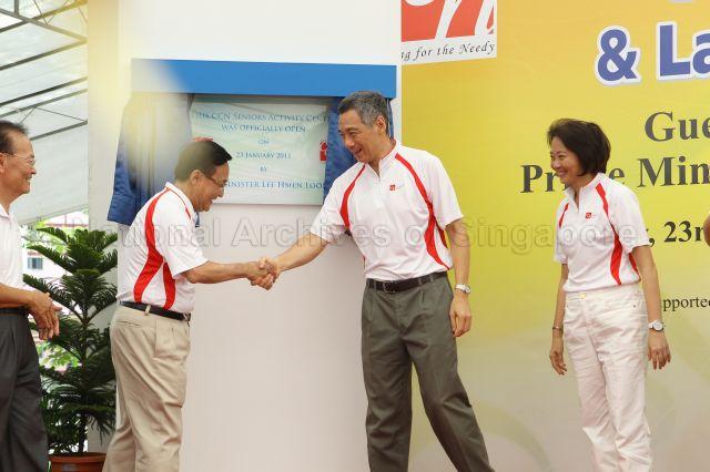 Prime Minister Lee Hsien Loong shaking hands with Member of Parliament (MP) for Yio Chu Kang Seng Han Thong after unveiling commemorative plaque during opening of Community Care Network (CCN) community fair for senior citizens and launch of CCN Senior Activity Centre (CCNSAC) at Block 420, Ang Mo Kio Avenue 10. On the right is MP for Ang Mo Kio Group Representation Constituency (GRC) Lee Bee Wah.