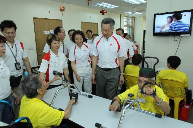 Prime Minister Lee Hsien Loong touring Community Care Network Senior Activity Centre (CCNSAC) at Block 420, Ang Mo Kio Avenue 10, during opening of CCN community fair for senior citizens and launch of the activity centre. Standing next to him is Member of Parliament for Ang Mo Kio Group Representation Constituency (GRC) Lee Bee Wah.