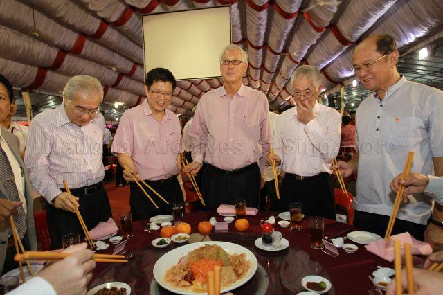 (From left) Grassroots leader Pang Pok, Member of Parliament for Marine Parade Group Representation Constituency (GRC) Ong Seh Hong, Senior Minister Goh Chok Tong, Chairman of Kampong Ubi-Kembangan Citizens' Consultative Committee Teo Cheng Swee and grassroots leader George Goh preparing to toss yusheng (or 'lo hei' in Cantonese, meaning ‘tossing luck’) at Kampong Ubi-Kembangan community reunion dinner held at open field next to Eunos Mass Rapid Transit (MRT) station