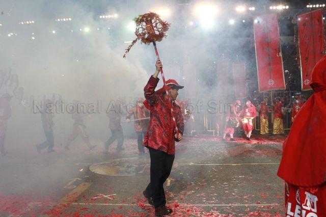 Chief Executive Director of People's Association Yam Ah Mee participating in a dragon dance performance at second night of Chingay parade 2011 at F1 Pit Building, Marina Bay. The event was attended by President S R Nathan and Senior Minister Goh Chok Tong.