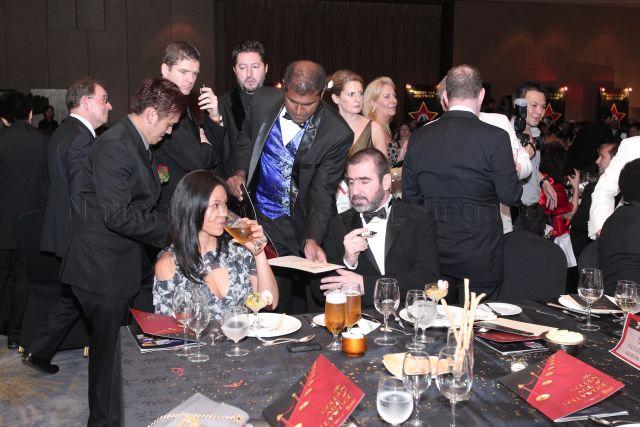 Manchester United's player of the century Eric Cantona (seated, right) at Bone Marrow Donor Programme (BMDP) charity gala themed "The Golden Age of Hollywood" held at Mandarin Orchard Hotel
