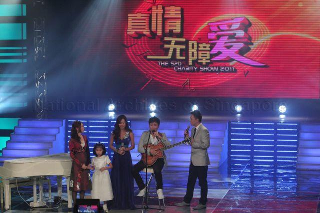 Hosts for the show Guo Liang and Michelle Chia with Kelvin Tan Wei Lian, a visually impaired Singaporean singer, and eight-year-old Korean child pianist with a visual impairment Yoo Ye Eun at Society for the Physically Disabled (SPD)'s charity show held at Mediacorp television auditorium