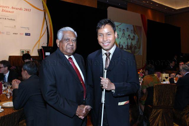 President S R Nathan posing for photographs with a visually impaired guest during the inaugural Enabling Employers Awards dinner held at Marina Bay Sands Grand Ballroom