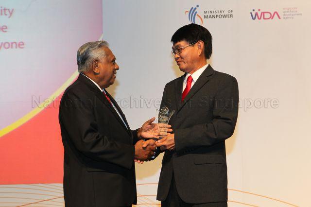 President S R Nathan presenting award trophy to Kentucky Fried Chicken's (KFC) Chief Executive Officer Michael Gian, who receives the award on behalf of Pizza Hut Singapore, during the inaugural Enabling Employers Awards dinner held at Marina Bay Sands Grand Ballroom