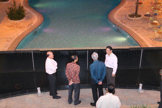 Senior Minister Goh Chok Tong (in blue shirt, back to camera) with office bearers of Singapore Polytechnic Graduates' Guild (SPGG) when he arrives to attend SPGG dialogue titled 'What is Singapore's Future?' held at its grand ballroom in Dover Road