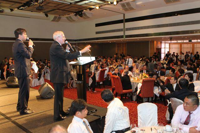 Celebrity father-son masters of ceremonies, Brian Richmond and his son Mark Richmond, holding an auction to raise funds for Boys' Town New Building Fund during Boys' Town gala charity dinner at Marriott Hotel in Orchard Road. Among the guests are President and Mrs S R Nathan.