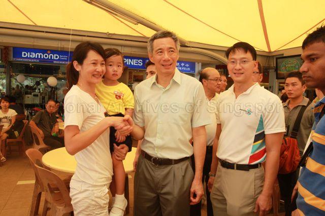 Prime Minister Lee Hsien Loong with Member of Parliament for Ang Mo Kio Group Representation Constituency (GRC) Dr Lam Pin Min touring Koufu food court in Fernvale Point during Sengkang West Wellness Day
