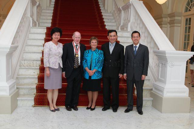 Professor Edward Holmes, who has been conferred the prestigious Honorary Citizen Award for his valuable contributions in Singapore biomedical industry, and Mrs Holmes with (from left) Permanent Secretary to Ministry of Health Ms Yong Ying-I, &nbsp;Chairman of Agency of Science, Technology and Research (A*Star) Lim Chuan Poh and Chairman of Economic Development Board (EDB) Leo Yip in a group photograph at Istana where the conferment ceremony is held