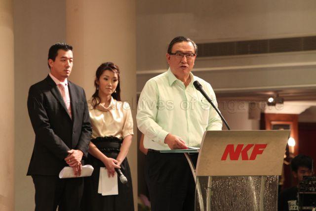 Chairman of National Kidney Foundation (NKF) Gerard Ee speaking at NKF's 100-table charity dinner held at Grand Ballroom, Orchid Country Club. On the left are Channel NewsAsia presenters Nicholas Fang and Ms Suzanne Jung, the masters of ceremonies for the event.