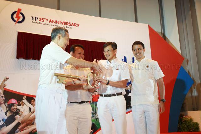 Prime Minister Lee Hsien Loong receiving the symbolic key to 'unlock' People's Action Party (PAP) manifesto slogan for the general election from Chairman of Young PAP (YP) Teo Ser Luck during YP's 25th Anniversary Rally at NTUC Centre auditorium in Marina Boulevard. Also on stage are YP Vice-Chairmen Zaqy Mohamad and Christopher de Souza (right).