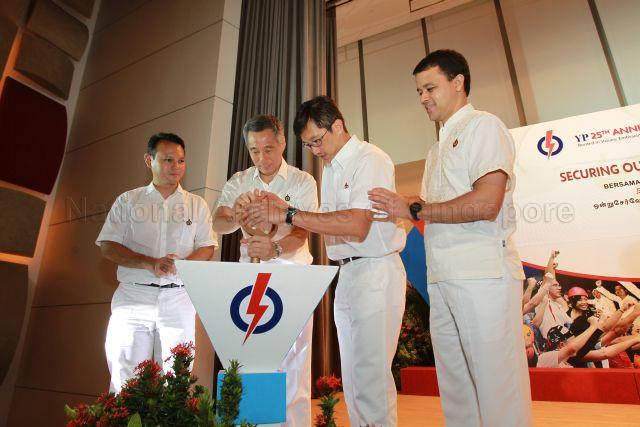 Prime Minister Lee Hsien Loong using the symbolic key to 'unlock' People's Action Party (PAP) manifesto slogan for the general election during 25th Anniversary Rally of Young PAP (YP) at NTUC Centre auditorium in Marina Boulevard. With him are YP Chairman Teo Ser Luck, YP Vice-Chairmen Christopher de Souza (right) and Zaqy Mohamad.