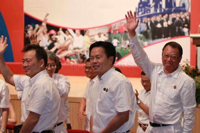 Retiring Members of Parliament in the forthcoming general election, including Mr Sin Boon Ann (left), Associate Professor Koo Tsai Kee (partially hidden) and Mr Ong Kian Min, waving to the audience during 25th Anniversary Rally of Young People's Action Party (YP) at NTUC Centre auditorium in Marina Boulevard. Also stepping down is Mr Eric Low Siak Meng (right), PAP candidate in opposition-held Hougang.