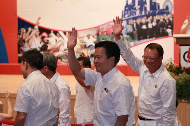 Mr Ong Kian Min (left) and Mr Eric Low Siak Meng, who will retire in the forthcoming general election, waving to the audience during 25th Anniversary Rally of Young People's Action Party (YP) at NTUC Centre auditorium in Marina Boulevard