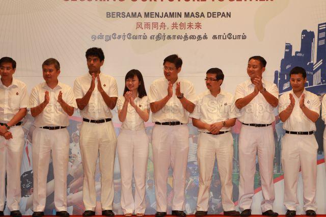 New People's Action Party (PAP) candidates for the forthcoming general election, from right, Desmond Lee, Steve Tan Peng Hoe, Zainal Sapari, Gan Thiam Poh, Ms Tin Pei Ling, Vikram Nair, Ang Hin Kee and Ang Wei Neng at 25th Anniversary Rally of Young PAP (YP) held at NTUC Centre auditorium in Marina Boulevard