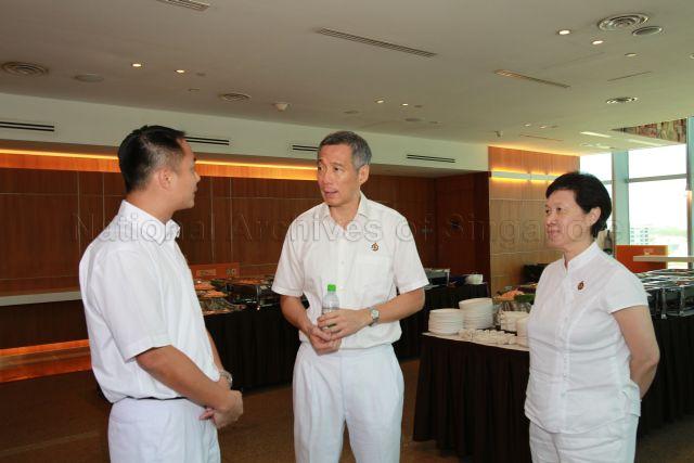 Prime Minister Lee Hsien Loong and wife, Madam Ho Ching, with new People's Action Party (PAP) candidate for Tampines Group Representation Constituency (GRC) Steve Tan Peng Hoe at the reception during 25th Anniversary Rally of Young People's Action Party (YP) at NTUC Centre auditorium in Marina Boulevard
