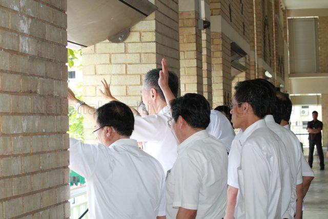 General Election 2011 - People's Action Party (PAP) candidates, including Prime Minister Lee Hsien Loong (back to camera), for Ang Mo Kio Group Representation Constituency (GRC) waving to supporters at Deyi Secondary School in Ang Mo Kio Street 42, the nomination centre for electoral divisions of Ang Mo Kio, Aljunied, Bishan-Toa Payoh and Sengkang West