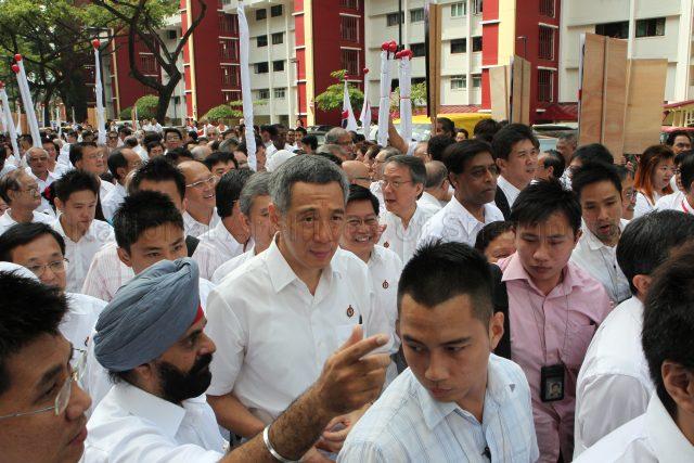 General Election 2011 - Prime Minister Lee Hsien Loong and fellow People's Action Party (PAP) candidates for Ang Mo Kio Group Representation Constituency (GRC) with supporters walking through housing estate in Ang Mo Kio on nomination day. Deyi Secondary School at 1 Ang Mo Kio Street 42 was nomination centre for electoral divisions of Ang Mo Kio, Aljunied, Bishan-Toa Payoh and Sengkang West.