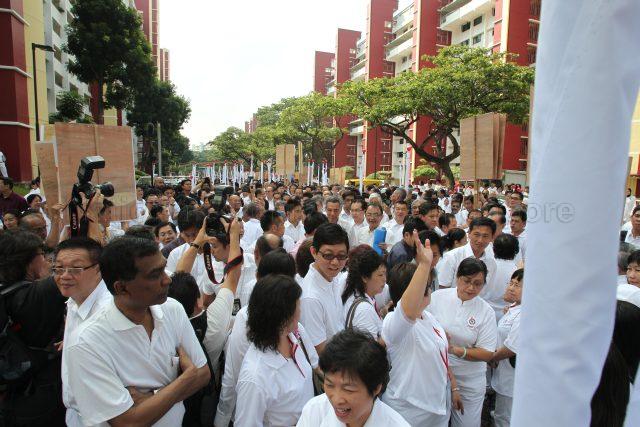 General Election 2011 - Prime Minister Lee Hsien Loong and fellow People's Action Party (PAP) candidates being surrounded by supporters and the media as they walk through housing estate in Ang Mo Kio on nomination day. Deyi Secondary School at 1 Ang Mo Kio Street 42 was nomination centre for electoral divisions of Ang Mo Kio, Aljunied, Bishan-Toa Payoh and Sengkang West.