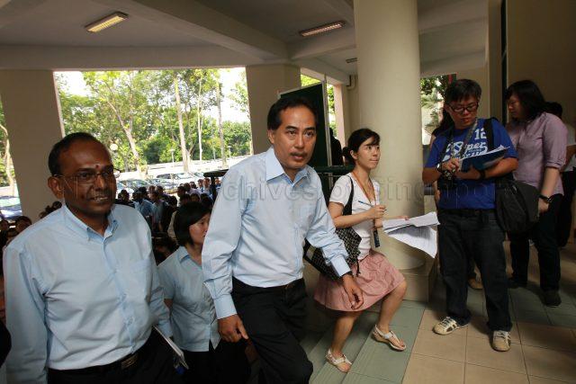 General Election 2011 - Workers' Party (WP) candidates for Moulmein-Kallang Group Representation Constituency (GRC) Mohd Rahizan bin Yaacob, L Somasundaram and Ms Frieda Chan Sio Phing (partially hidden) arriving at Singapore Chinese Girls' School, 190 Dunearn Road, the nomination centre for electoral divisions of Tanjong Pagar GRC, Moulmein-Kallang GRC, Radin Mas and Whampoa