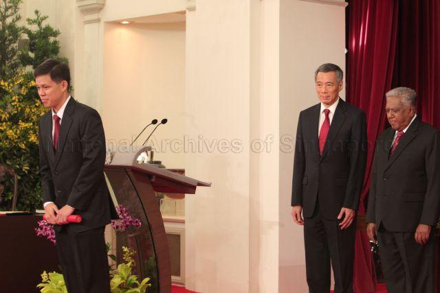 Acting Minister for Community Development, Youth and Sports (MCYS) and Minister of State for Information, Communications and the Arts (MICA) Chan Chun Sing bowing to the audience after receiving the instrument of appointment from President S R Nathan, during the swearing-in ceremony at Istana. Also looking on is Prime Minister Lee Hsien Loong.