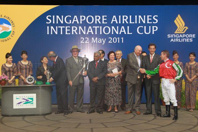 (From fourth from left) Singapore Turf Club Chairman Tan Guong Ching, Herman Brown Sr (father of winning trainer Herman Brown), President S R Nathan, SIA Chairman Stephen Lee (partially hidden), Mrs Herman Brown, Tote Board Chairman Bobby Chin, bloodstock agent Andy William, winning trainer Herman Brown, and winning jockey Glyn Schofield during prize presentation ceremony of SIA Cup at Turf Club