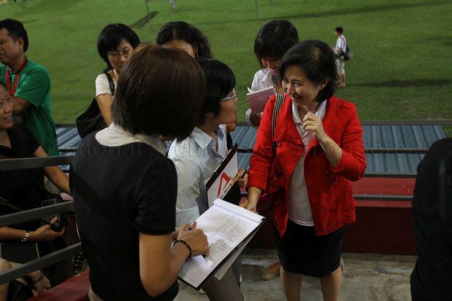 Tan Ming Li, daughter of presidential candidate Dr Tan Cheng Bock, being interviewed by the press during the waiting of presidential election result at Jurong East Stadium