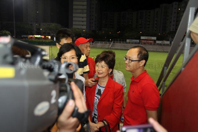Mrs Cecilia Tan and Joshua Tan, wife and son of presidential candidate Dr Tan Cheng Bock, being interviewed by the media during waiting of presidential election result at Jurong East Stadium