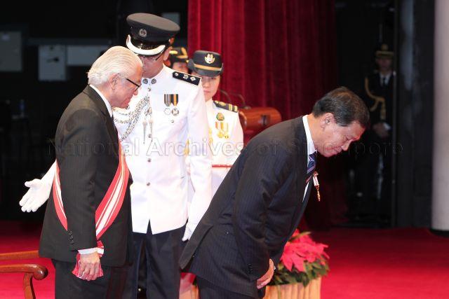 President Tony Tan Keng Yam presenting Meritorious Service Medal to Chairman of Changi Airport Group Liew Mun Leong at investiture of National Day awards held at University Cultural Centre Hall, National University of Singapore in Kent Ridge