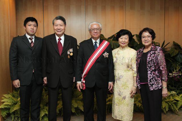 Group photograph of President and Mrs Tony Tan Keng Yam with Chairman of Singapore Children's Society and recipient of Meritorious Service Medal Koh Choon Hui and his family during investiture of National Day awards at University Cultural Centre, National University of Singapore in Kent Ridge