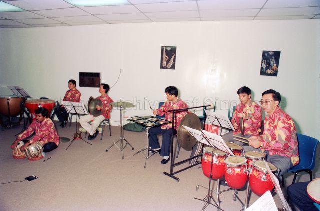 Chinese Orchestra Drummers at People's Association, Cultural Section - Players practising on the instruments.
