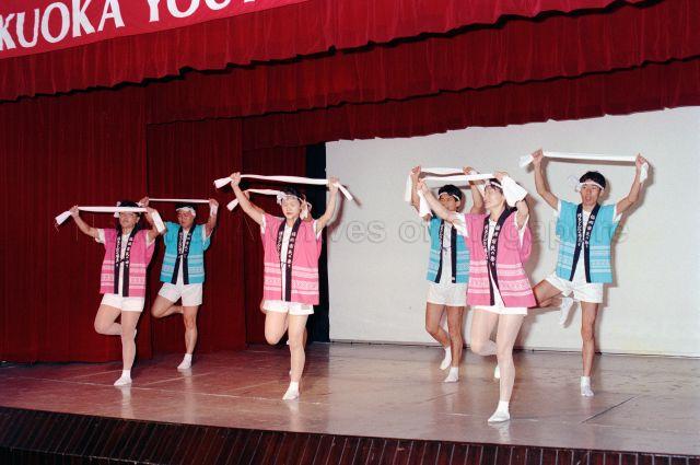 Fukuoka Youth Delegation at the People's Association Headquarters - Japanese dance performance on stage.