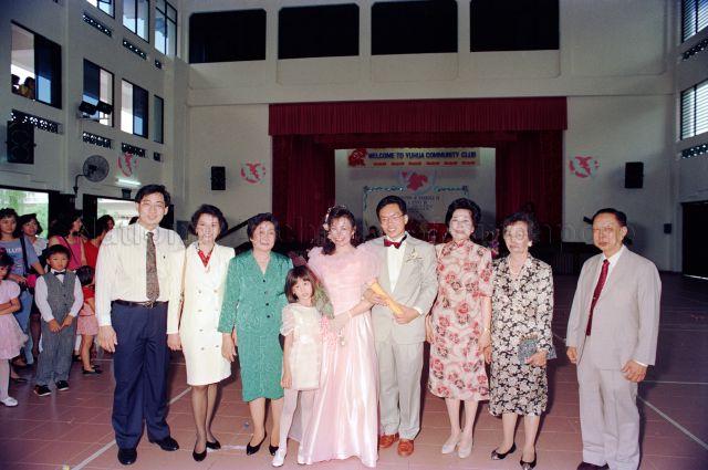 Solemnisation of Marriage at Yuhua Community Club - Group photo of bride and groom with guests.
